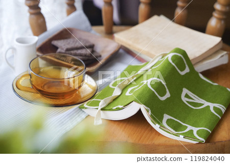 Paperback book with handmade book cover, biscuits and tea, reading 119824040