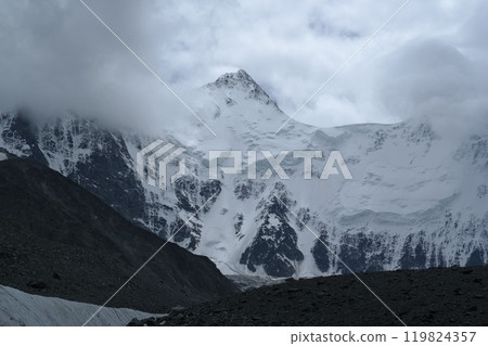 Tranquil Lake With Lush Green Forest, Snow-Capped Mountain, Blue Sky And White Clouds 119824357