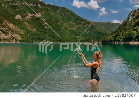 Woman in Swimwear Splashing Water in Mountain Lake 119824507