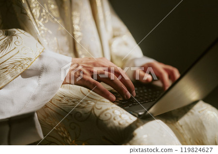 Medium close up of unrecognizable male hands typing on black keyboard 119824627