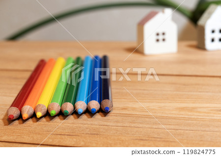 A house figurine placed on a wooden board 119824775