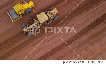Aerial view road motor grader flatting dirt road surface, Motor grader road construction grader industrial machine on construction site of new road, Mortor grader on work. Aerial view road motor grader flatting dirt road surface, Motor grader road construction grader industrial machine on construction site of new road, Mortor grader on work. 119825944