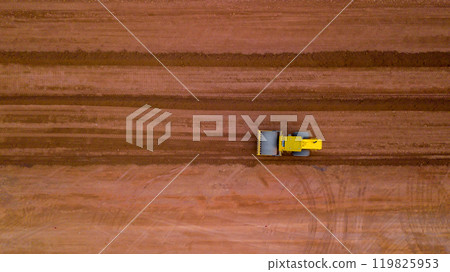 Aerial view road motor grader flatting dirt road surface, Motor grader road construction grader industrial machine on construction site of new road, Mortor grader on work. Aerial view road motor grader flatting dirt road surface, Motor grader road construction grader industrial machine on construction site of new road, Mortor grader on work. 119825953