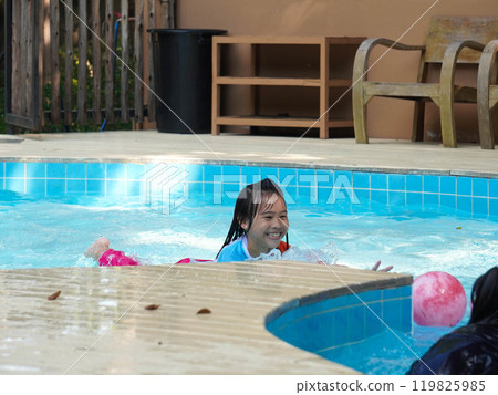 Girl having fun jumping into the pool. Summer holidays and vacation concept Girl having fun jumping into the pool. Summer holidays and vacation concept 119825985