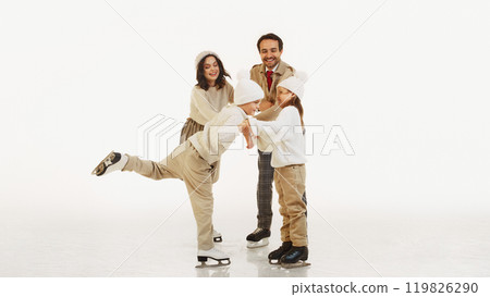 Happy winter weekends. Joyful smiling family, parents and tow kids enjoying lovely time on ice rink. Cozy warm outfits Happy winter weekends. Joyful smiling family, parents and tow kids enjoying lovely time on ice rink. Cozy warm outfits 119826290