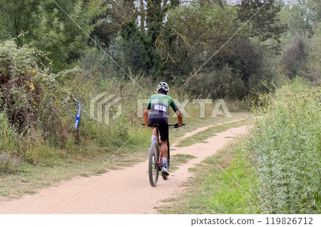 rear view athlete riding mountain bike in cross country race rear view athlete riding mountain bike in cross country race 119826712