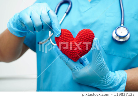 Asian woman doctor holding red heart for health in hospital. 119827122