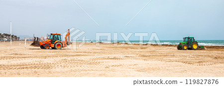 Heavy Machinery Clearing Sand and Seaweed From a Beach on a Sunny Day Near the Coastline Heavy Machinery Clearing Sand and Seaweed From a Beach on a Sunny Day Near the Coastline 119827876