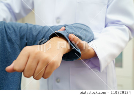 Physical therapy, Asian therapist doctor treat perform pain therapy in hospital. Physical therapy, Asian therapist doctor treat perform pain therapy in hospital. 119829124