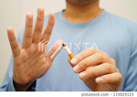 Quit smoking, Asian man breaking destroy cigarette in hand. Quit smoking, Asian man breaking destroy cigarette in hand. 119829125