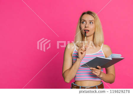 Woman making notes writing down thoughts with pen into notepad notebook diary to do list good idea 119829278
