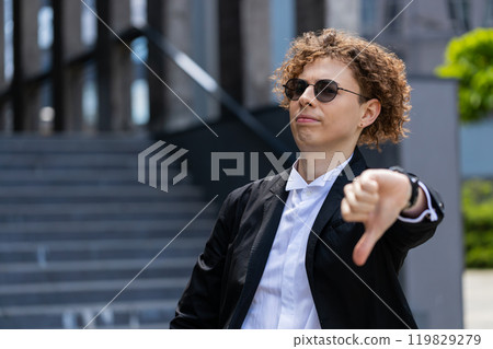 Businessman showing thumbs down sign gesture expressing discontent disapproval dissatisfied mistake 119829279