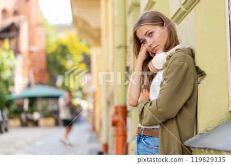 Frustrated Caucasian young woman thinking of money debt budget loss bankruptcy on urban city street Frustrated Caucasian young woman thinking of money debt budget loss bankruptcy on urban city street 119829335