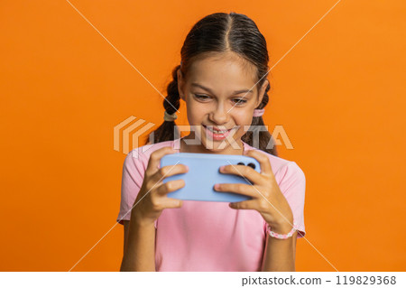 Happy girl playing racing drive simulator shooter video games on smartphone celebrate victory win Happy girl playing racing drive simulator shooter video games on smartphone celebrate victory win 119829368