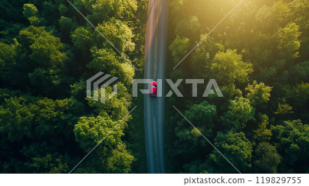 A car driving on a winding forest road surrounded by green trees on a sunny day. Generative AI 119829755