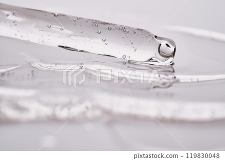 Dropper pipette with delicious serum with bubbles on the gel texture. 119830048