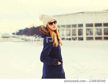 Fashion winter pretty blonde woman wearing a jacket hat and sunglasses Fashion winter pretty blonde woman wearing a jacket hat and sunglasses 119830340