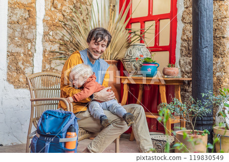 Father and his son tourists in a colonial house in San Cristobal de las Casas, Mexico. Cultural exploration, architecture, and travel experience concept Father and his son tourists in a colonial house in San Cristobal de las Casas, Mexico. Cultural exploration, architecture, and travel experience concept 119830549