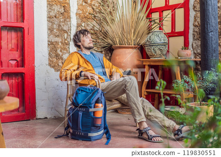 Male tourist in a colonial house in San Cristobal de las Casas, Mexico. Cultural exploration, architecture, and travel experience concept Male tourist in a colonial house in San Cristobal de las Casas, Mexico. Cultural exploration, architecture, and travel experience concept 119830551