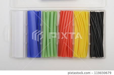 an organized plastic container holding a variety of heat shrink tubing in different colors 119830679