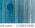 Garage door boards stained blue with worn paint. 119831046