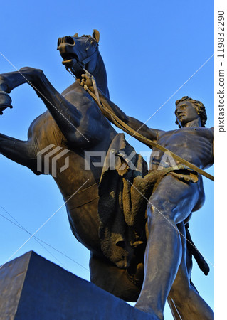 famouse horse sculpture against blue sky: The Horse Tamers, designed by the Russian sculptor, Baron Peter Klodt von Urgensburg. Anichkov bridge, Saint-Petersburg, Russia famouse horse sculpture against blue sky: The Horse Tamers, designed by the Russian sculptor, Baron Peter Klodt von Urgensburg. Anichkov bridge, Saint-Petersburg, Russia 119832290