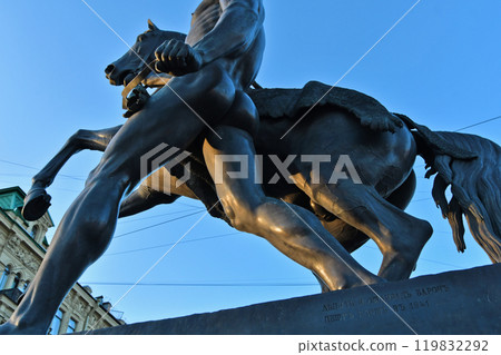 famouse horse sculpture against blue sky: The Horse Tamers, designed by the Russian sculptor, Baron Peter Klodt von Urgensburg. Anichkov bridge, Saint-Petersburg, Russia famouse horse sculpture against blue sky: The Horse Tamers, designed by the Russian sculptor, Baron Peter Klodt von Urgensburg. Anichkov bridge, Saint-Petersburg, Russia 119832292