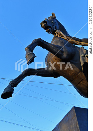 famouse horse sculpture against blue sky: The Horse Tamers, designed by the Russian sculptor, Baron Peter Klodt von Urgensburg. Anichkov bridge, Saint-Petersburg, Russia 119832294