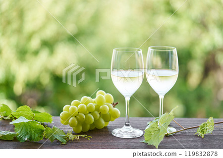 white wine poured into a glass 119832878