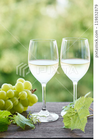 white wine poured into a glass 119832879