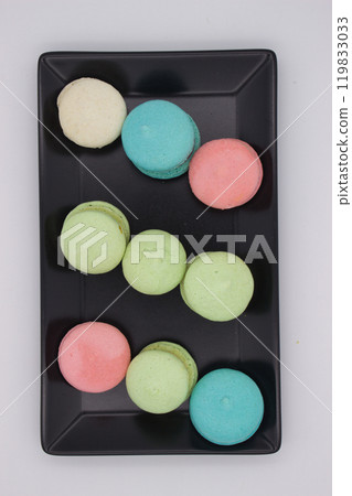 Colorful French macarons on a black plate Colorful French macarons on a black plate 119833033