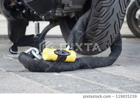 This is a secure motorcycle lock that features a heavyduty chain combined with a padlock This is a secure motorcycle lock that features a heavyduty chain combined with a padlock 119835239