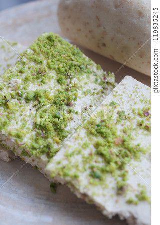 Indulge in delightful Indian sweets adorned with a scrumptious pistachio topping Indulge in delightful Indian sweets adorned with a scrumptious pistachio topping 119835245