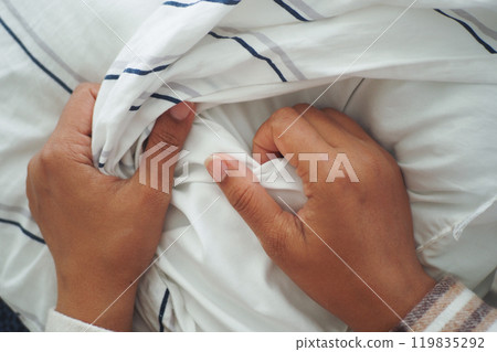 Woman Puts Pillow Into Pillowcase. Woman Puts Pillow Into Pillowcase. 119835292