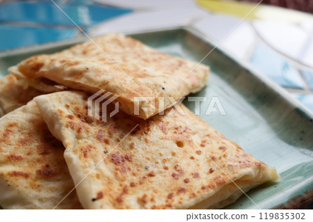 This exquisite and delicious golden brown flatbread is beautifully served on a lovely plate 119835302