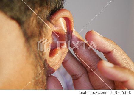 young man having ear pain touching his painful ear , 119835308