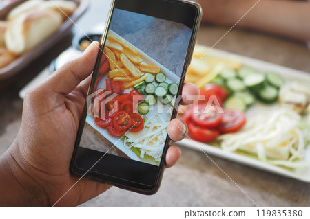 A vibrant display of healthy food showcased on a phone screen, featuring fresh ingredients 119835380