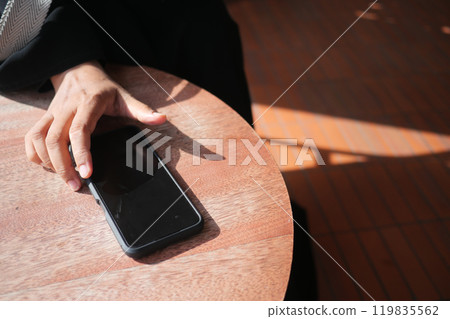 man hand picking up smart phone mobile to receive a call  119835562