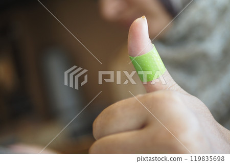 adhesive bandage on hand close up  119835698