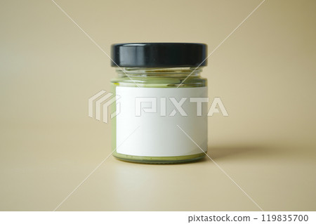 A Small Glass Jar featuring a Black Lid and a Blank Label designed for Various Customization A Small Glass Jar featuring a Black Lid and a Blank Label designed for Various Customization 119835700