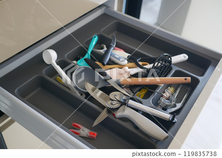 Close up of messy kitchen utensil drawer. Close up of messy kitchen utensil drawer. 119835738