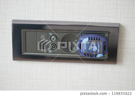 Close-Up of Electric Plug with Insect Repellent Device Close-Up of Electric Plug with Insect Repellent Device 119835822