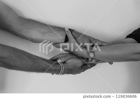 Two hands hold tightly to each other, rescuer saves, pulls out of trouble a person in need of help 119836606