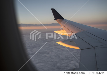 Airplane Wing Over Cloudscape at Sunrise Airplane Wing Over Cloudscape at Sunrise 119836694