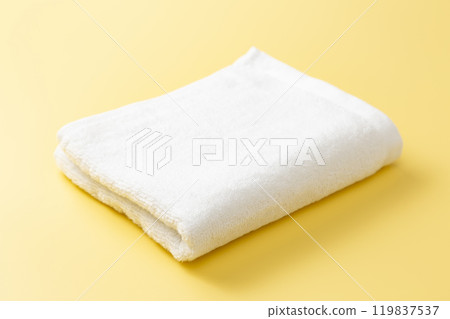 White towel on a yellow background 119837537