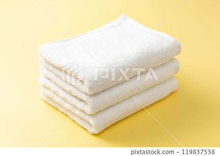 White towel on a yellow background White towel on a yellow background 119837538