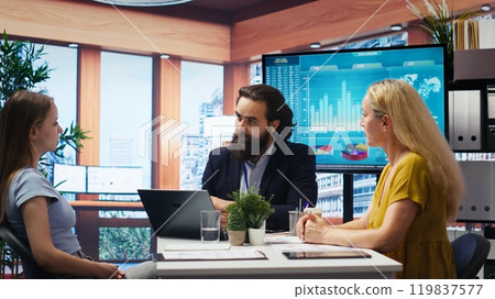 Financial adviser conducting audit of customers income, developing predictive financial models. Consultant crafts customized economic strategies based on customers goals and risk tolerance, camera B Financial adviser conducting audit of customers income, developing predictive financial models. Consultant crafts customized economic strategies based on customers goals and risk tolerance, camera B 119837577