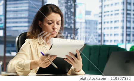 Corporate leader signing work contracts and agreements to approve leave requests and other documents for productivity. CEO businesswoman working on legal management, success story. Camera A. Corporate leader signing work contracts and agreements to approve leave requests and other documents for productivity. CEO businesswoman working on legal management, success story. Camera A. 119837583