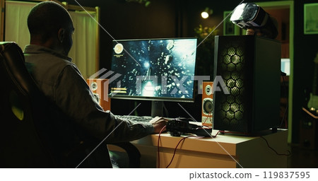 Person coming home to play SF videogame on PC desktop after finishing job shift. Gamer entering living room, starting spaceship flying game on computer in neon lit home late at night, camera B 119837595