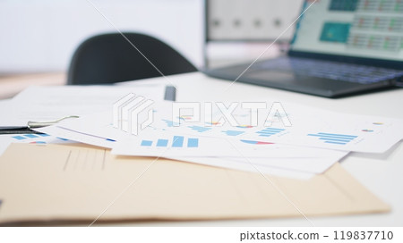 Empty financial department with stock portfolio on laptops and paperwork files filled with marketing charts. Close up shot of forex exchange indices on notebook screen Empty financial department with stock portfolio on laptops and paperwork files filled with marketing charts. Close up shot of forex exchange indices on notebook screen 119837710
